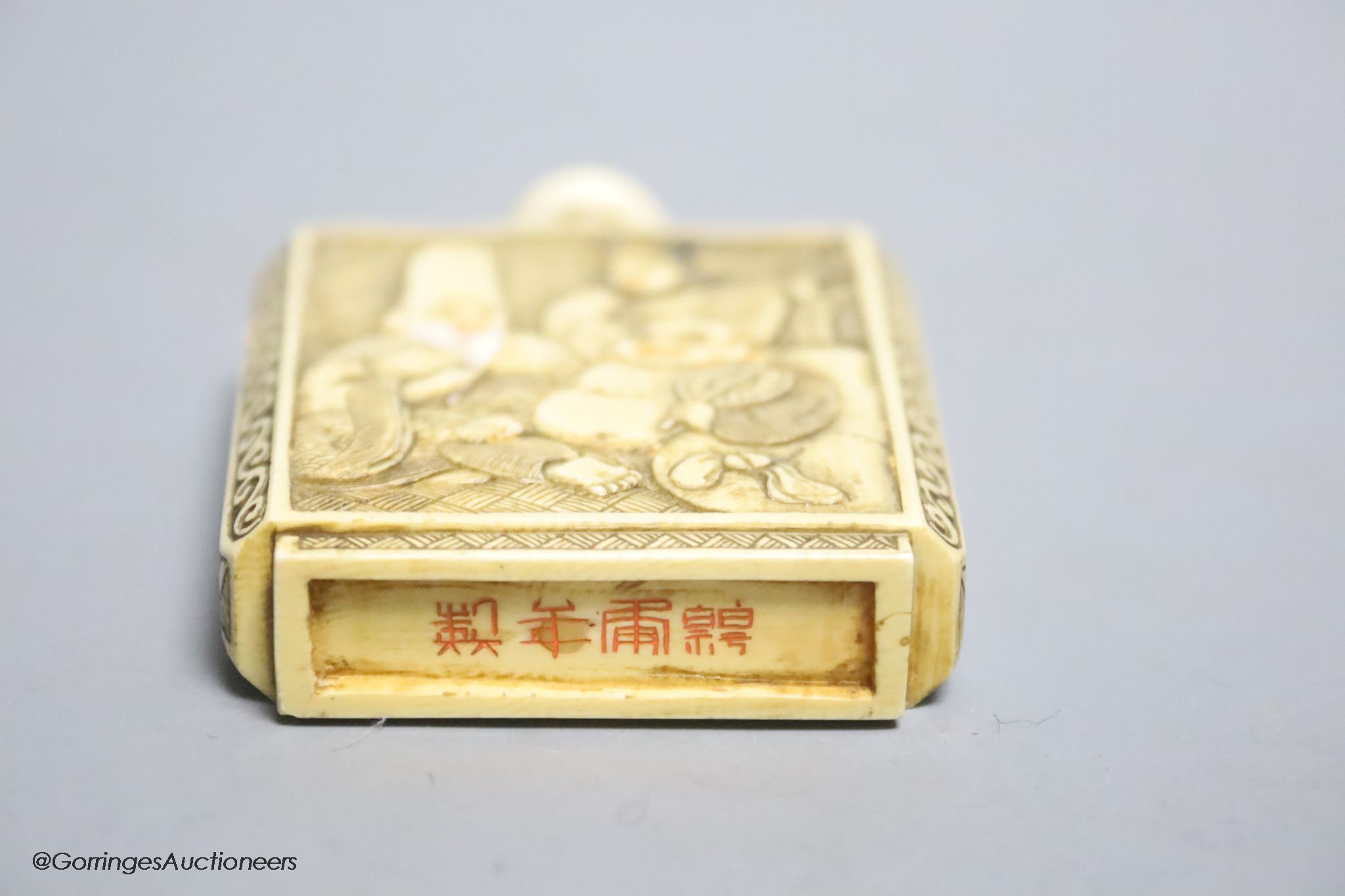 A Japanese carved ivory ‘Gods of Happiness’ snuff bottle, early 20th century